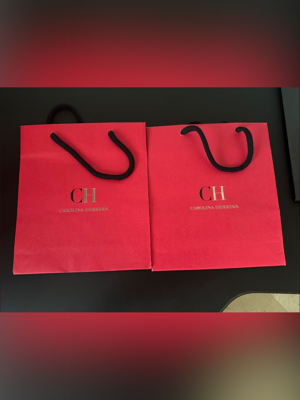 Carolina Herrera Red Gift Bags with Gold Logo and Black Handles and box